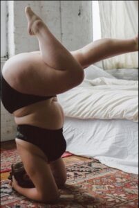 a man is laying on a bed with a towel on his head