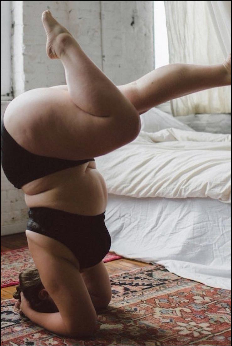 a man is laying on a bed with a towel on his head