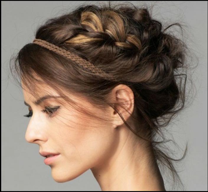 a woman with a black hair cut is wearing a black top