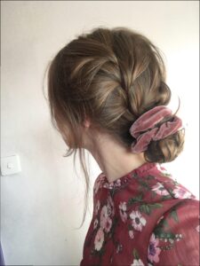 a woman is looking at a hair dryer