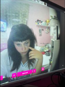 a woman is looking at a tv screen