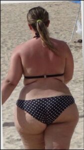 a woman in a bikini and a red and white striped shirt