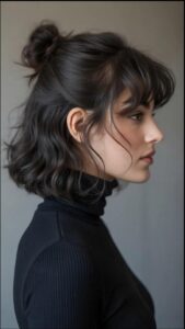 a woman with a black hair and a black tie