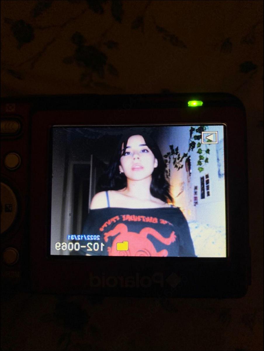 a woman is holding a tv on a wall