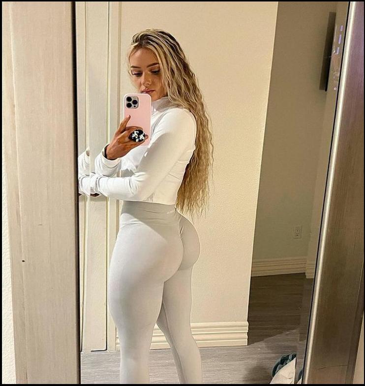 a woman is standing in front of a mirror