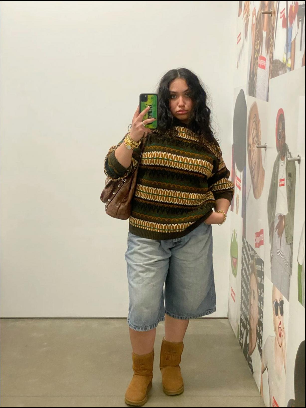 a woman is holding a drink and a phone