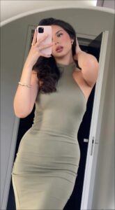 a woman is holding a cell phone to her face