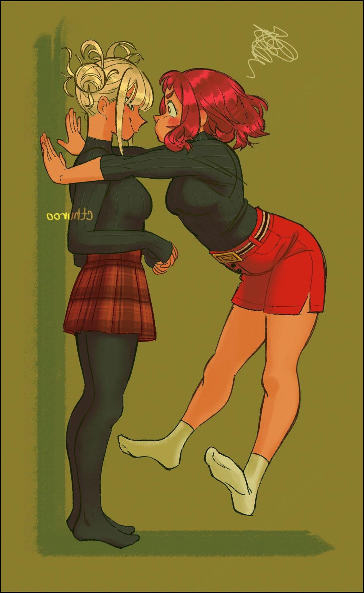 two women are posing for a picture with a painting