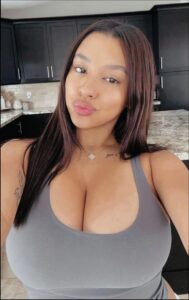 a woman is standing in a room with a black and white checkered wall