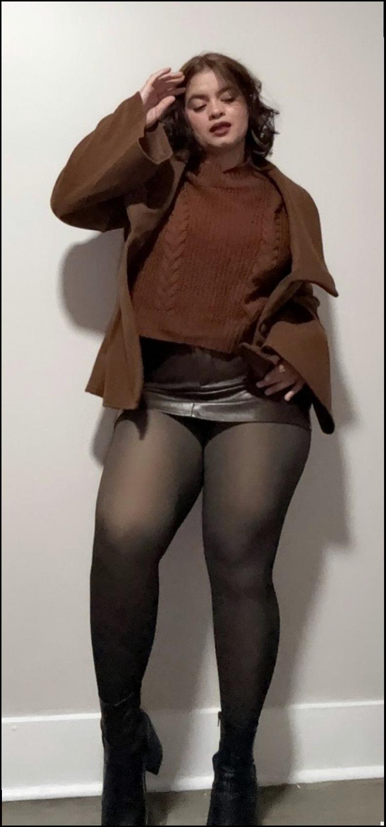 a woman in a black dress is on a cell phone