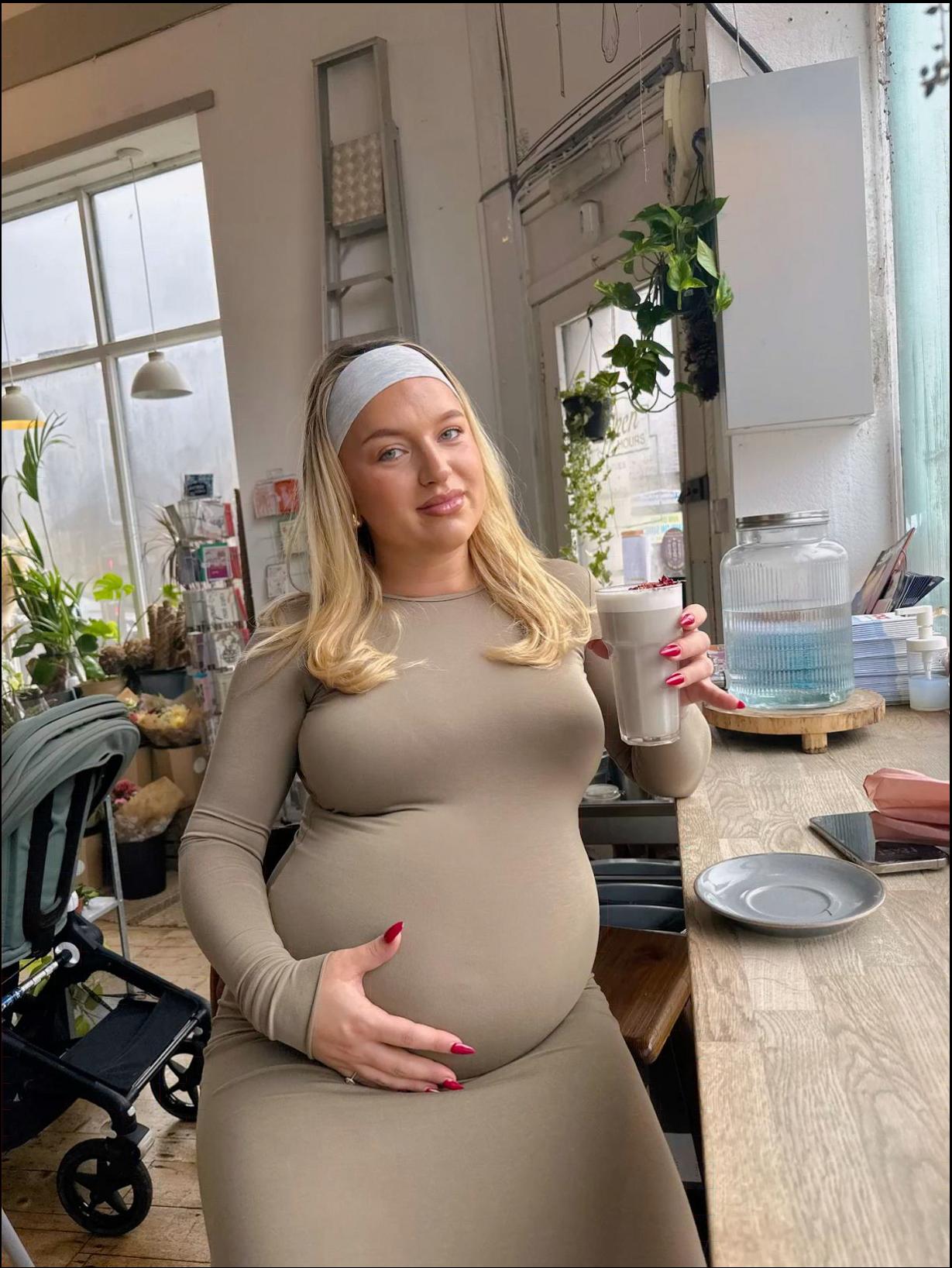 a woman dressed in a white dress and holding a white object