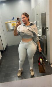 a man in a bathroom holding a white object