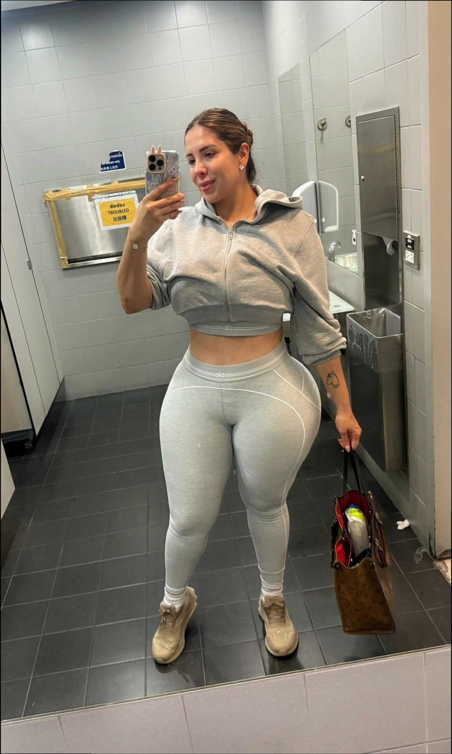 a man in a bathroom holding a white object