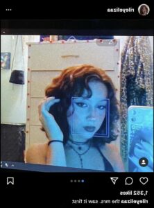 a woman is on a cell phone in front of a wall