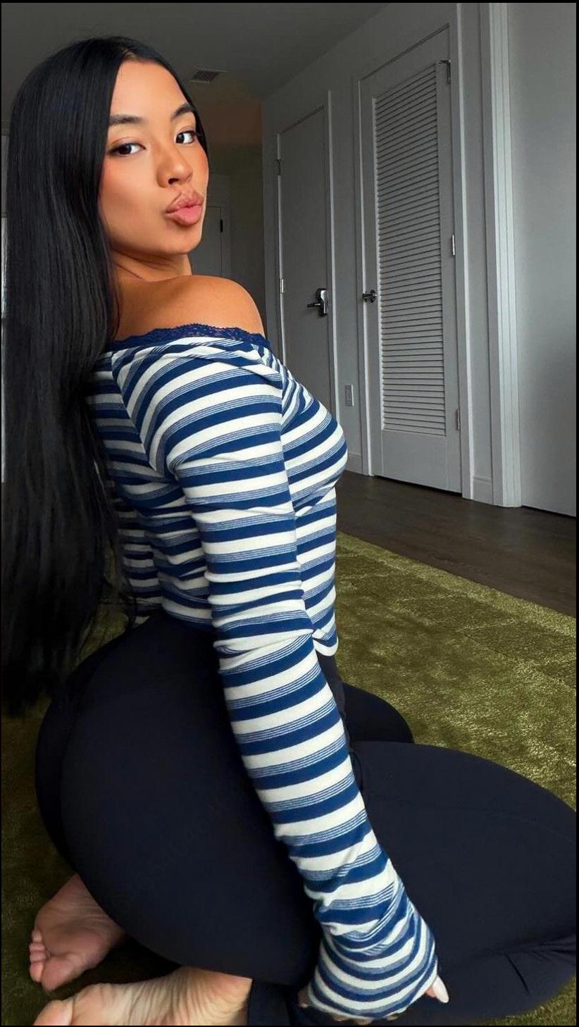 a woman is standing on a floor with a blue towel