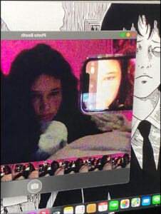 a woman is sitting on a bed with a picture of a cat on it