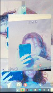 a person is holding a laptop and a picture