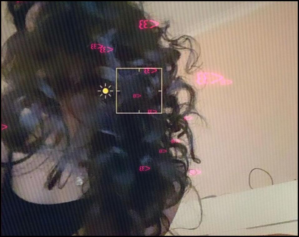 a woman with a red hair cut is looking at a cell phone