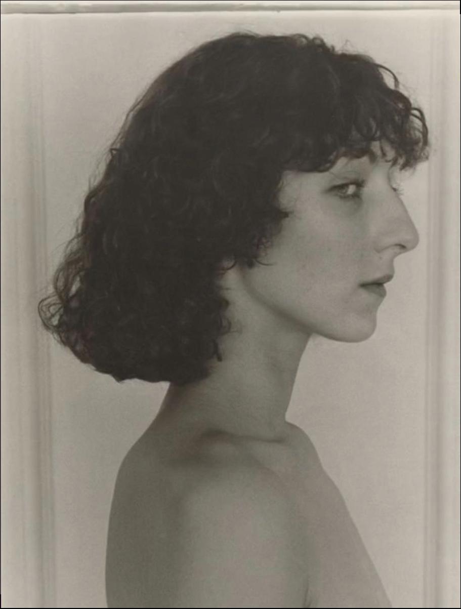 a woman is standing in a mirror with a white towel