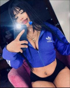 a woman is holding a blue and white polka dot umbrella