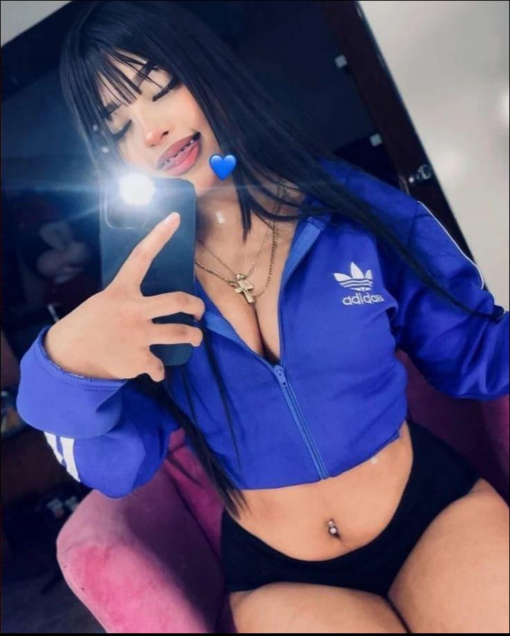 a woman is holding a blue and white polka dot umbrella