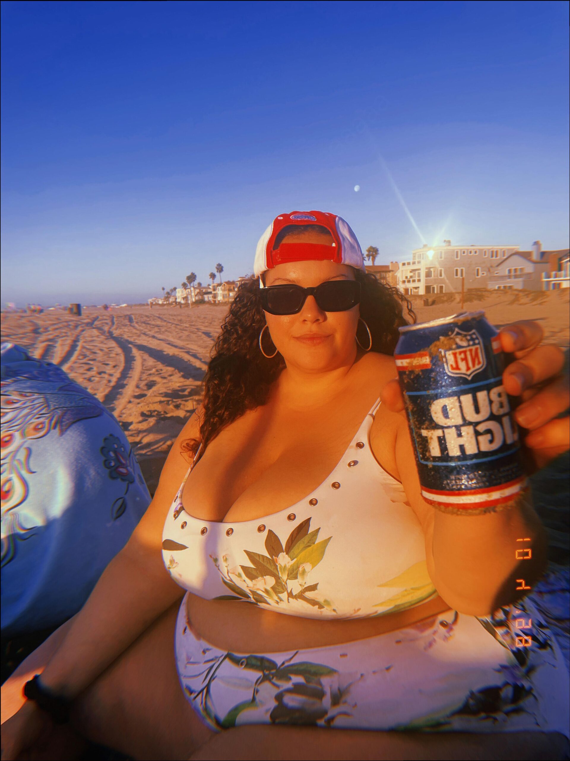 a woman is drinking a beer and a bottle of water