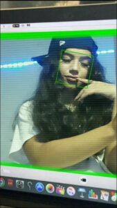 a woman is holding a laptop and a cat