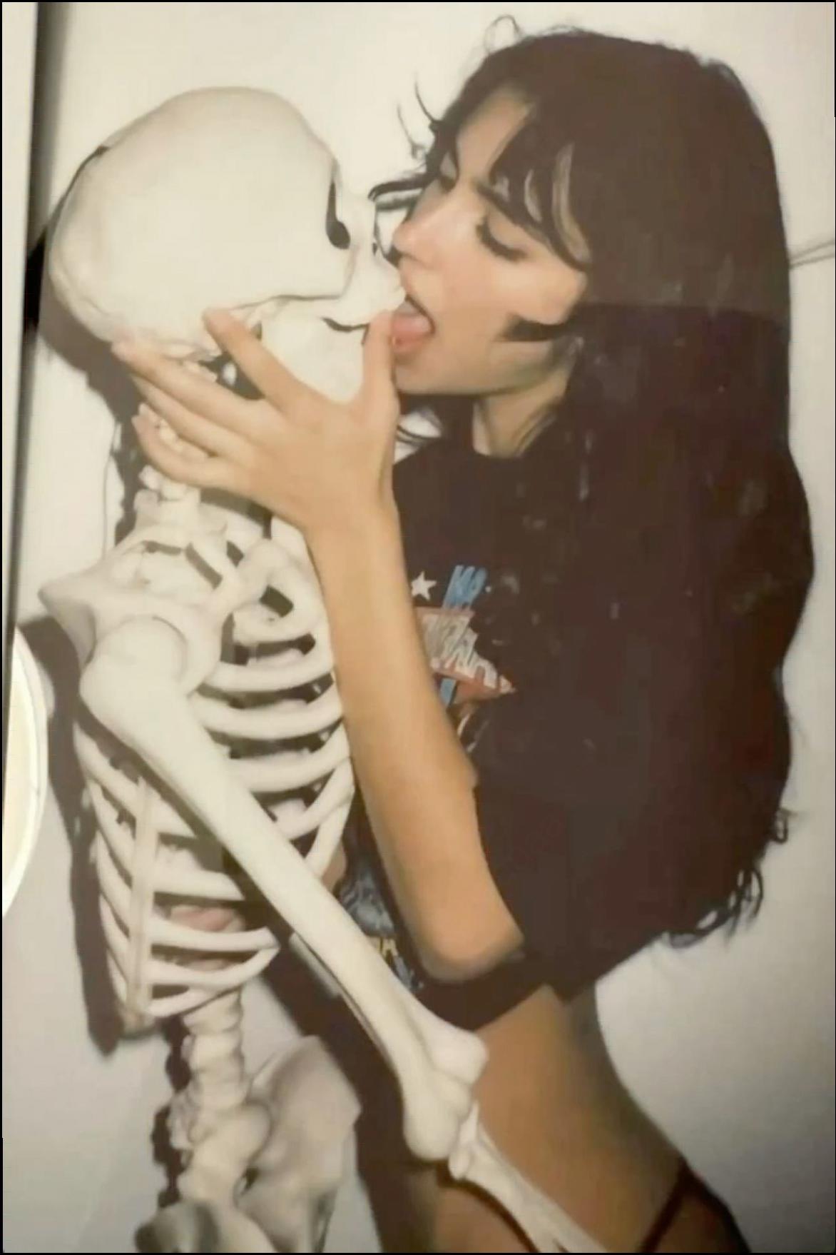 a woman is holding a phone up to her face