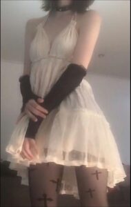 a woman in a black dress is holding a white object