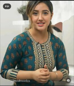 a woman is smiling while holding a cell phone