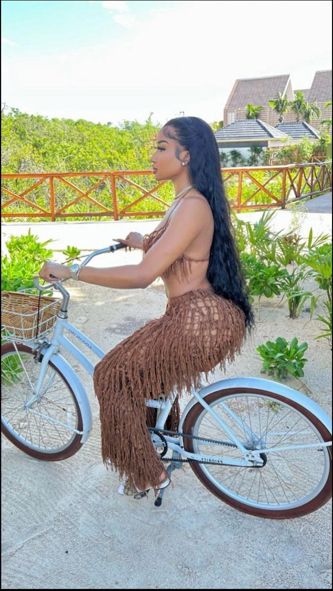 a woman is riding a bike on the street