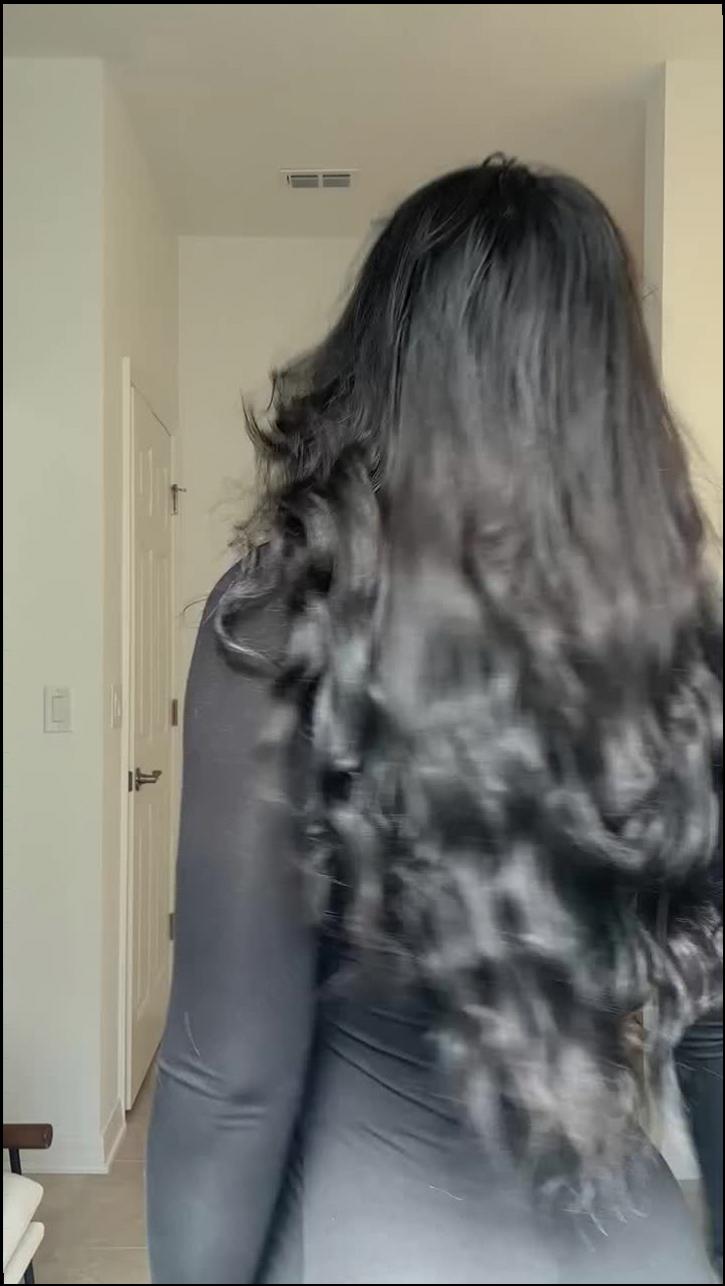 a woman with a black hair and a black top