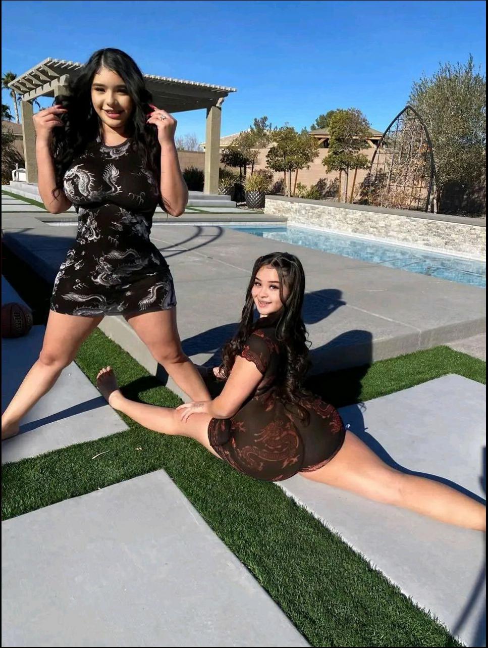a woman is sitting on a sidewalk with a tennis racket
