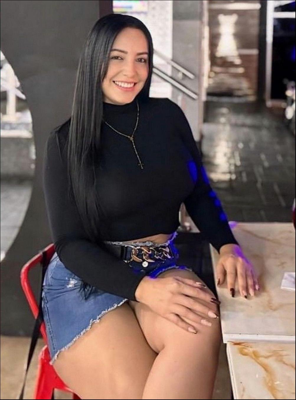 a woman sitting on a bench with a red tie