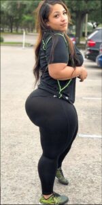 a woman is standing on a sidewalk with a skateboard