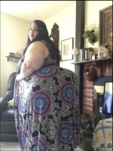 a woman is sitting on a chair in a room