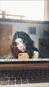 a woman is sitting on a laptop computer