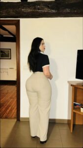 a woman is standing on a wooden floor