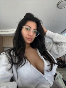 a woman is holding a cell phone in her hand