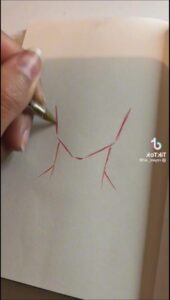 a person cutting a piece of paper with scissors