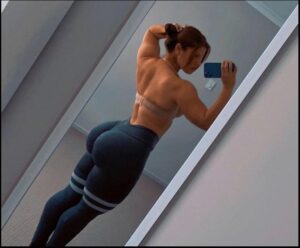 a man is standing on a wall with a phone