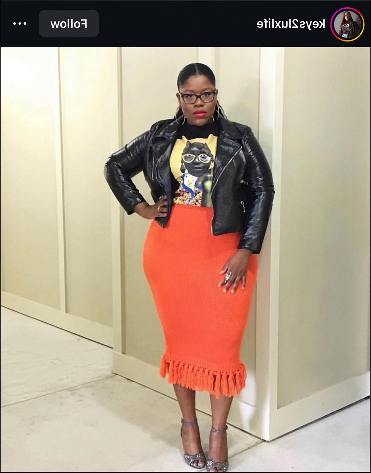 a woman in a red dress posing for a picture