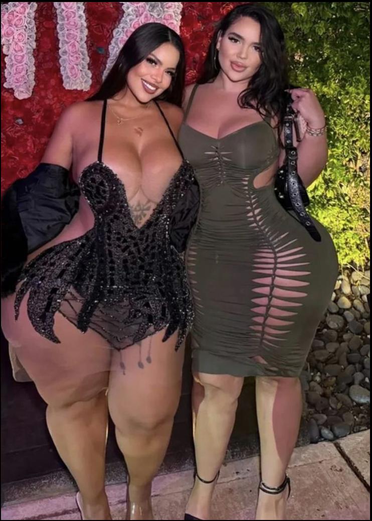 two women dressed in black and white posing for a picture