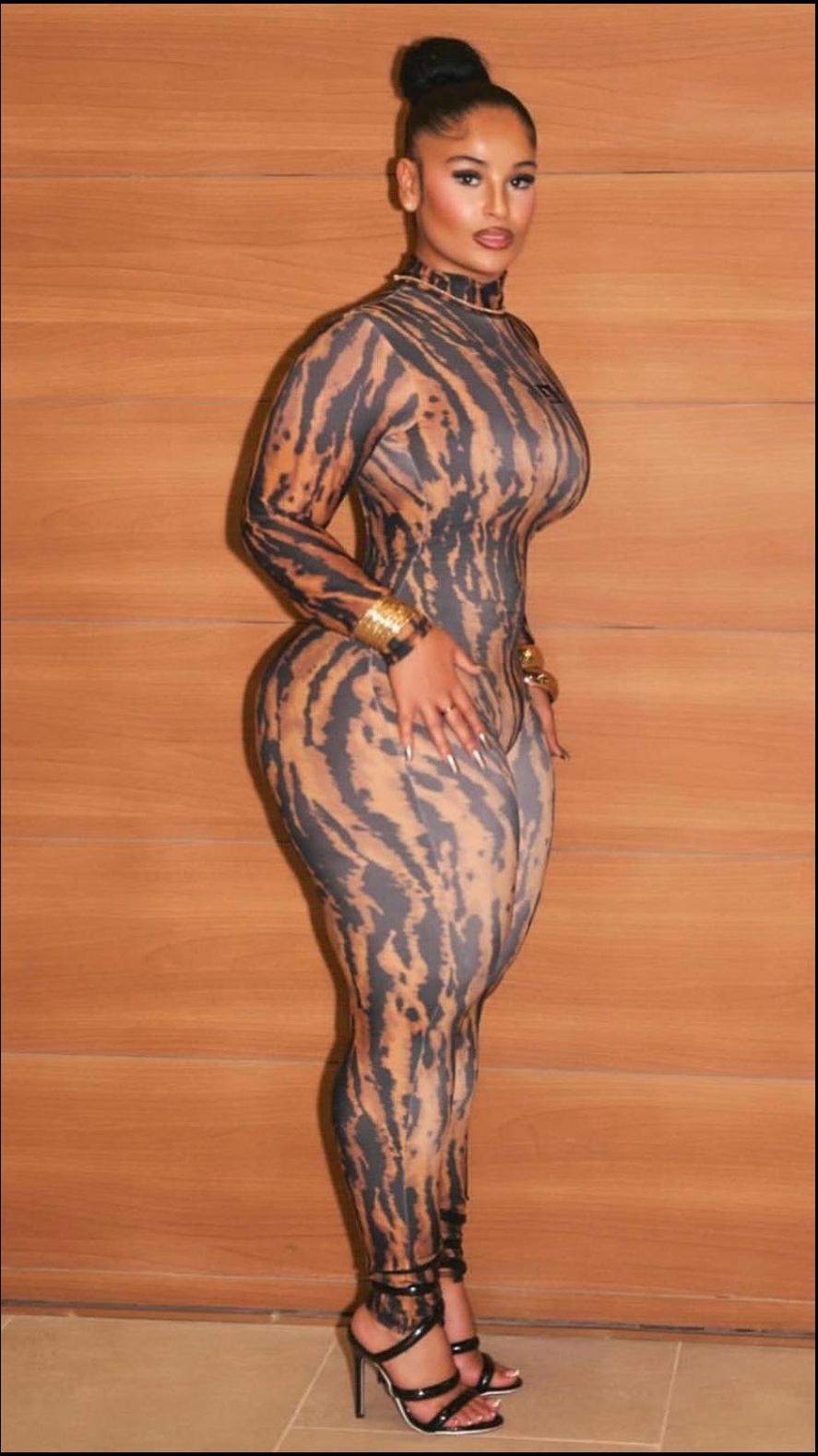 a woman in a black dress posing for a picture