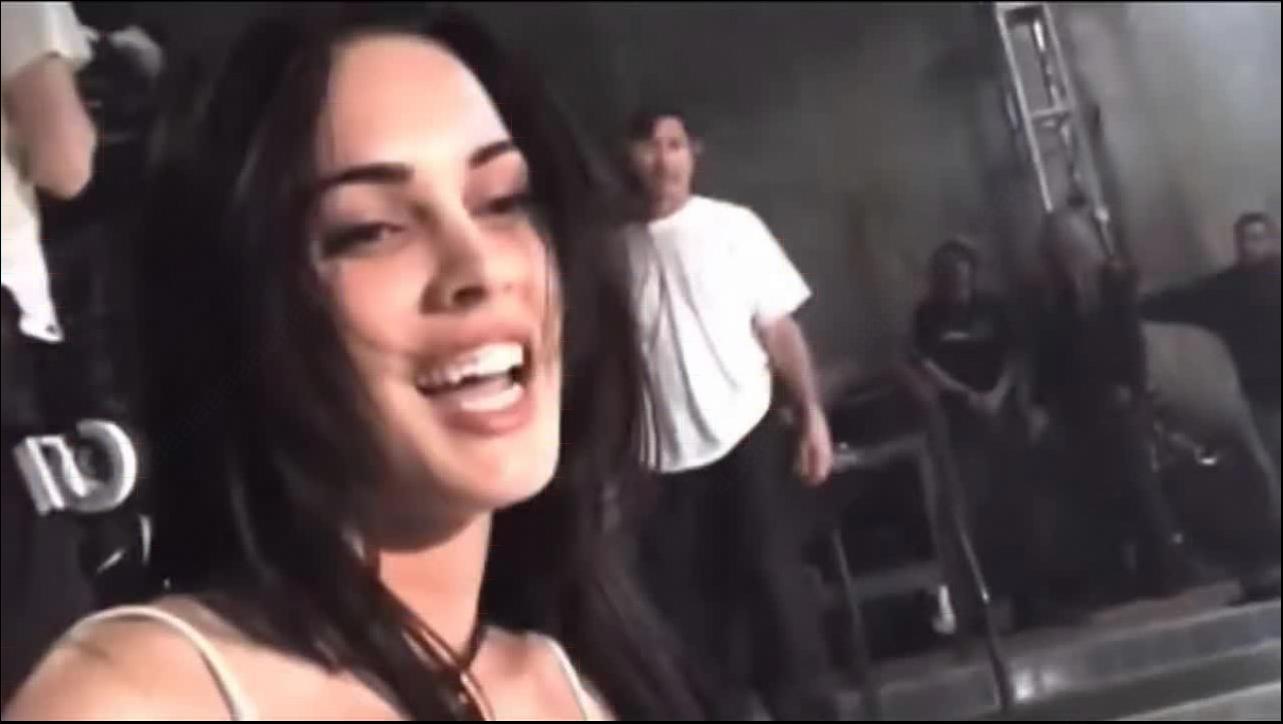 a woman is smiling while holding a cell phone