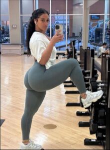 a woman is sitting on a bench and holding a cell phone