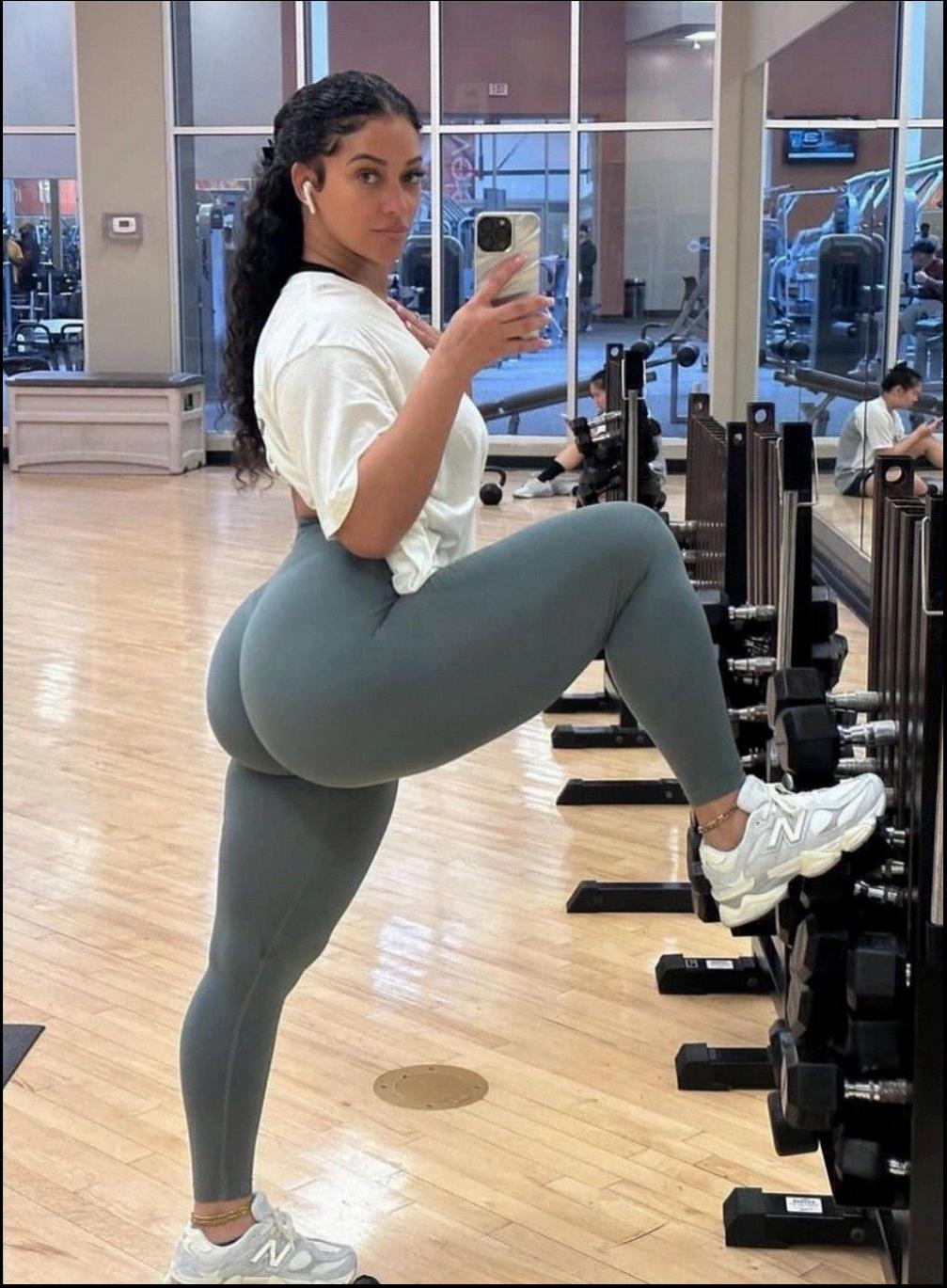 a woman is sitting on a bench and holding a cell phone