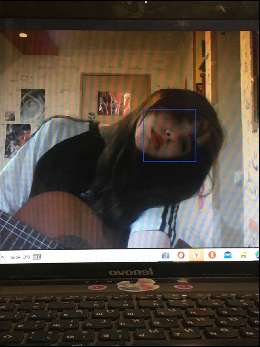 a woman is laying on a bed with a laptop