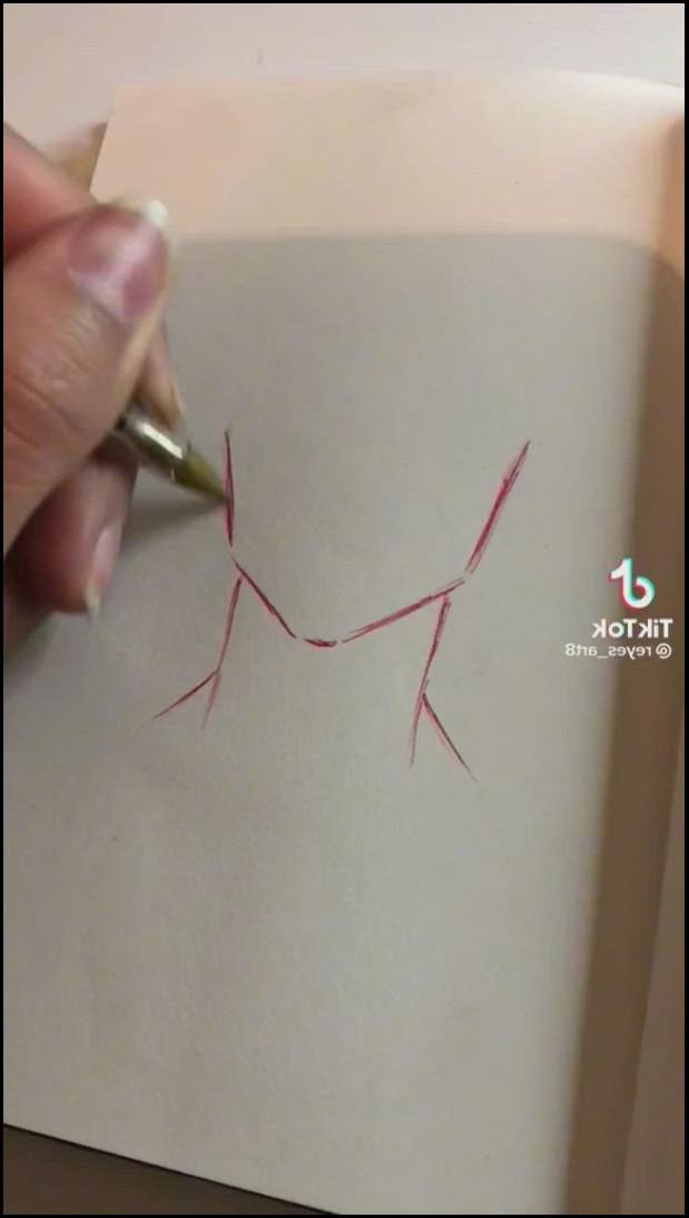 a person cutting a piece of paper with scissors