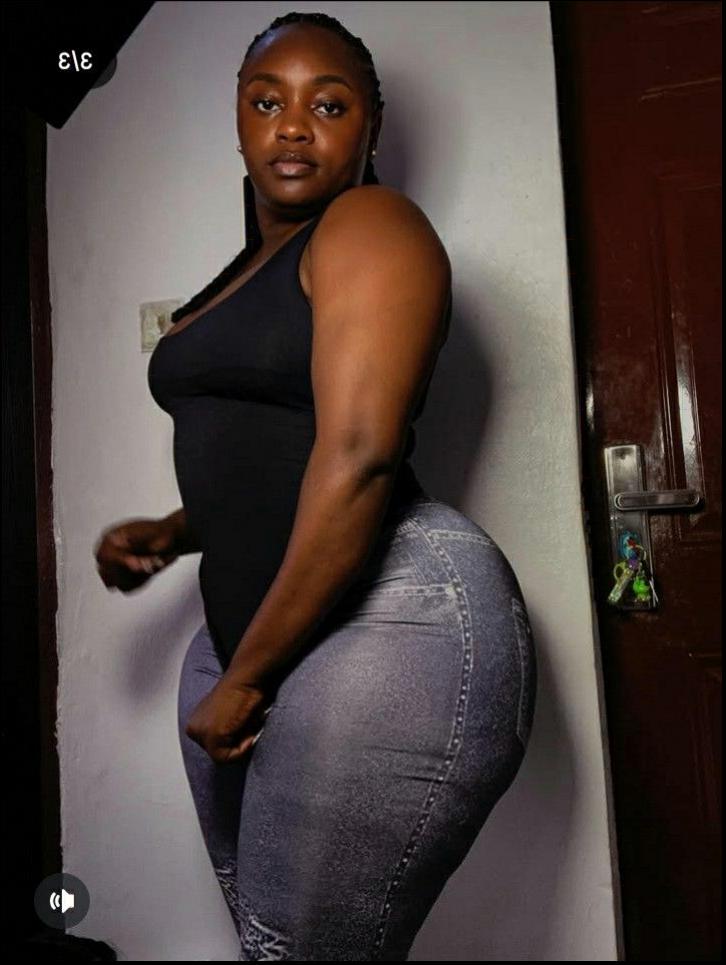 a woman is posing for a picture with a wall